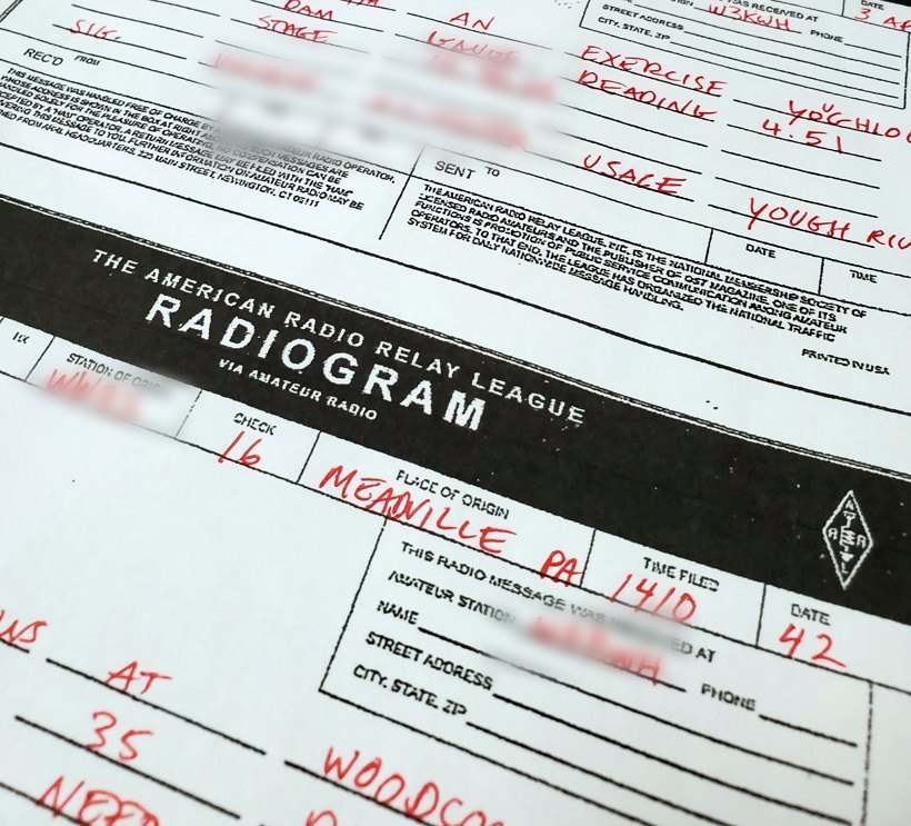 A real ARRL Radiogram form filled out by hand, with the bold 'RADIOGRAM via Amateur Radio' masthead and the ARRL diamond logo, its preamble and address boxes completed in red ink